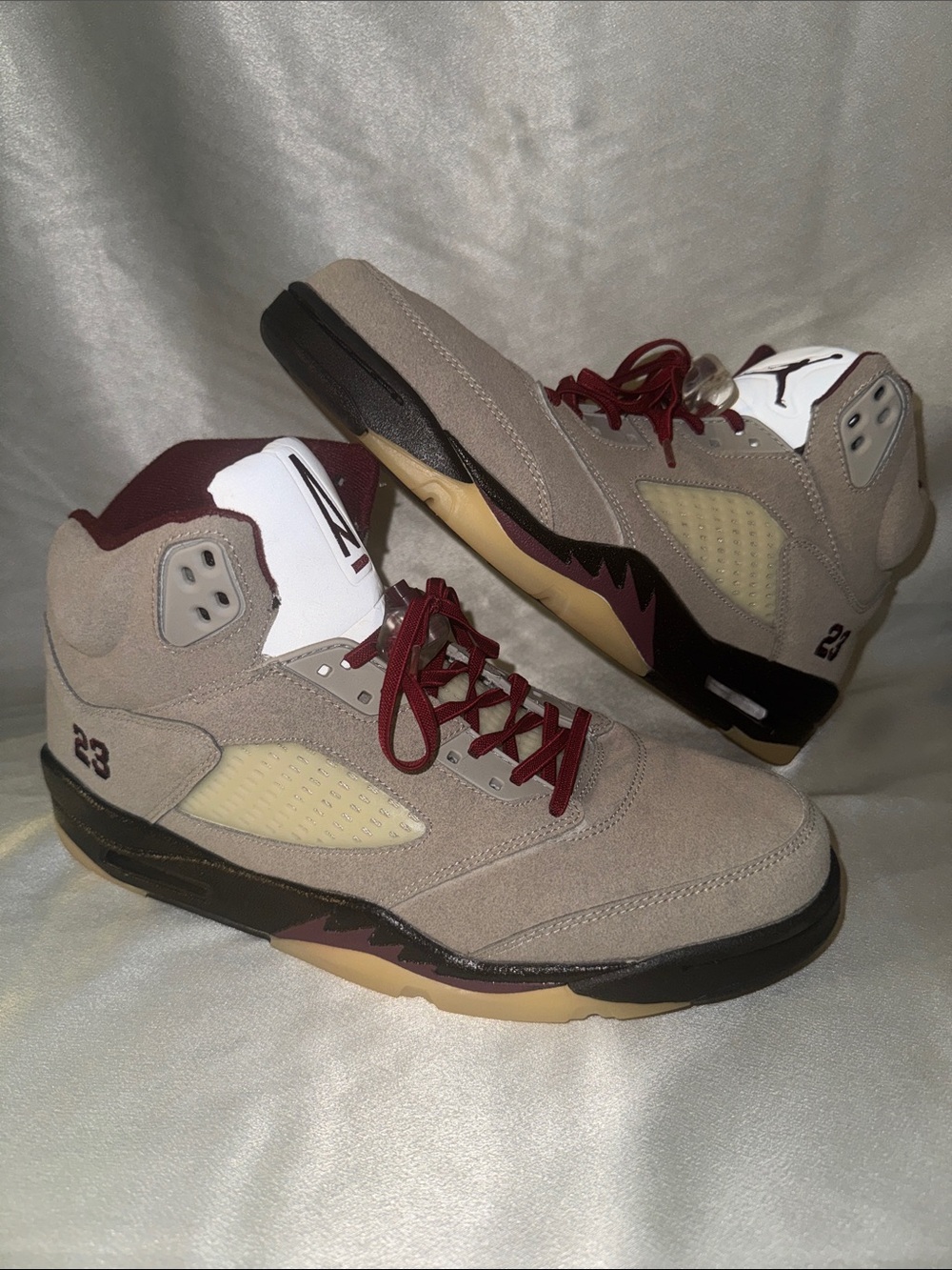 A Ma Maniére x Air Jordan 5 "Light Bone" features a light Grey Suede/Burgundy!